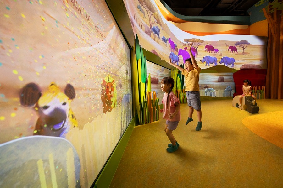 Kids exploring hands-on wildlife play zones at Curiosity Cove
